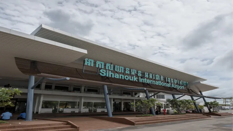 Landside facade of Sihanouk International Airport, showing the main terminal entrance and its signage in Khmer and English.